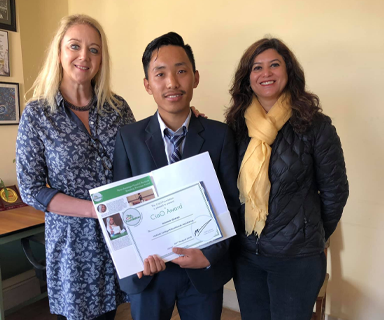 Karma receiving an award from the College Principal